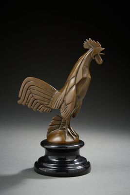 a bronze statue of a rooster on a black pedestal