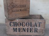 two wooden boxes that have chocolate menter on them
