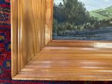 a picture of a painting of a landscape in a wooden frame