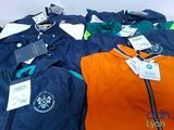 several jackets that are sitting on a table together