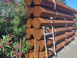 une grande pile de tuyaux en acier empilés les uns sur les autres dans un parking