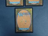 three decks of magic the gathering are displayed on a blue surface