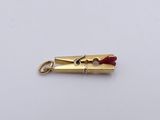 a small piece of gold with a red handle on it