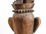 a wooden vase that has a flower on top of it
