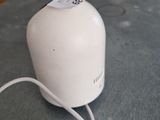 a white toaster sitting on the floor with a tag on it