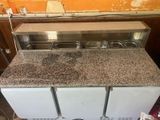 an image of a kitchen with a counter top and a refrigerator