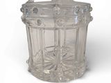 a clear glass jar with a lid on a white surface