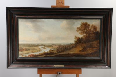 painting on easel of a landscape with a river and a village in the distance