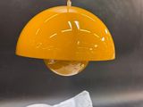 a yellow light hanging over a sink in a kitchen
