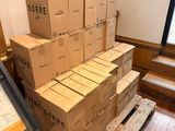 a pile of boxes sitting on a pallet in the middle of a room