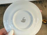 a person holding a white plate with a picture on it