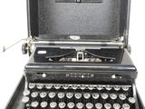 an old typewriter sitting in a case on a white surface