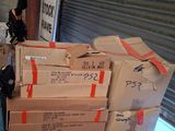 a pile of boxes on a pallet in front of a garage door