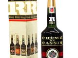 a bottle of creme cassis is next to a box of wine