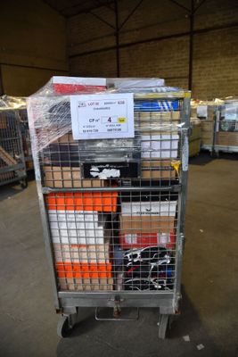 a metal cart with many boxes on it in a warehouse