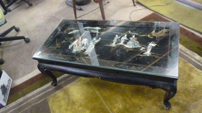 une table avec un plateau en verre sur lequel est représentée une image de chevaux