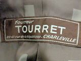 a label on a jacket that says tourret