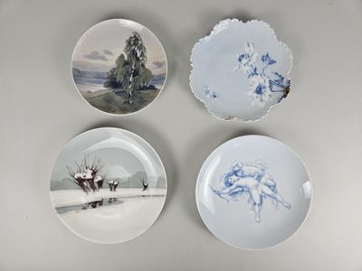 three plates with blue and white designs on them sitting on a table