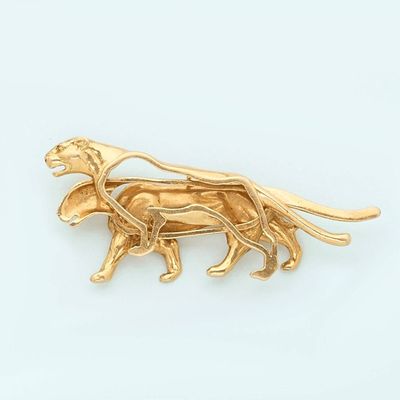 an image of a gold dog broochle on a white background