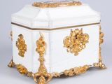 a white and gold box with gold decorations on it