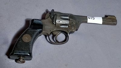 a gun with a tag on it sitting on a table