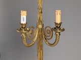 a gold chandelier with three candles hanging from it