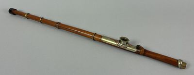 a close up of a wooden and metal instrument on a white surface
