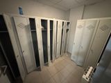 many lockers in a room with white tile flooring