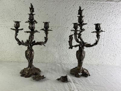 deux chandeliers en métal posés sur une table