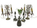several candles and a vase with flowers on a white surface