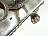 a silver plate with a clock on top of it