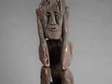 an old wooden statue of a monkey with its head in the air