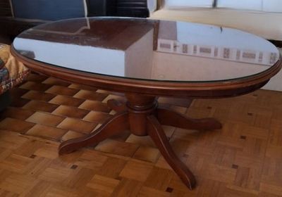 a glass table with a book on it in a living room