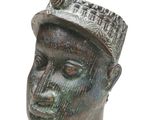 statue of a man with a hat and a bird on his head