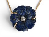 an image of a necklace with a blue flower on it