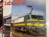 two books on a table with a train in the background