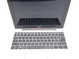 a laptop computer with a keyboard on a white surface