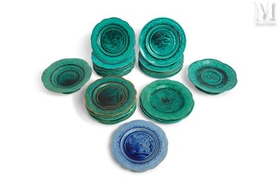 plusieurs morceaux de verre bleu et vert posés sur une surface blanche