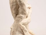 an image of a sculpture of a woman sitting on a rock