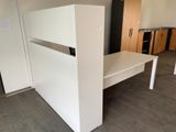 an image of a kitchen with a white table and cabinets