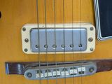 a close up of a guitar that is on a table