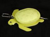 a yellow turtle shaped keychain with a key chain attached to it