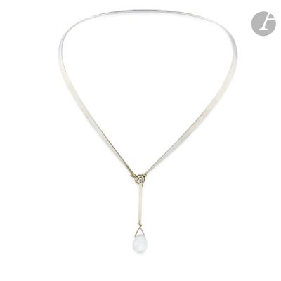 a close up of a necklace with a pearl on a white background