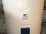 an image of a white water heater on the floor