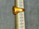 a gold ring sitting on top of a thermometer