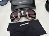 a pair of sunglasses sitting on a table next to a pair of glasses
