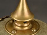 a gold lamp that is sitting on top of a table