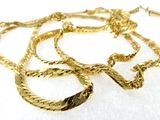 gold plated necklace with twisted rope design on a white background