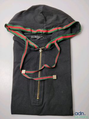 a close up of a black shirt with a red and green hoodie