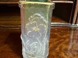 a glass vase on a table with a number on it